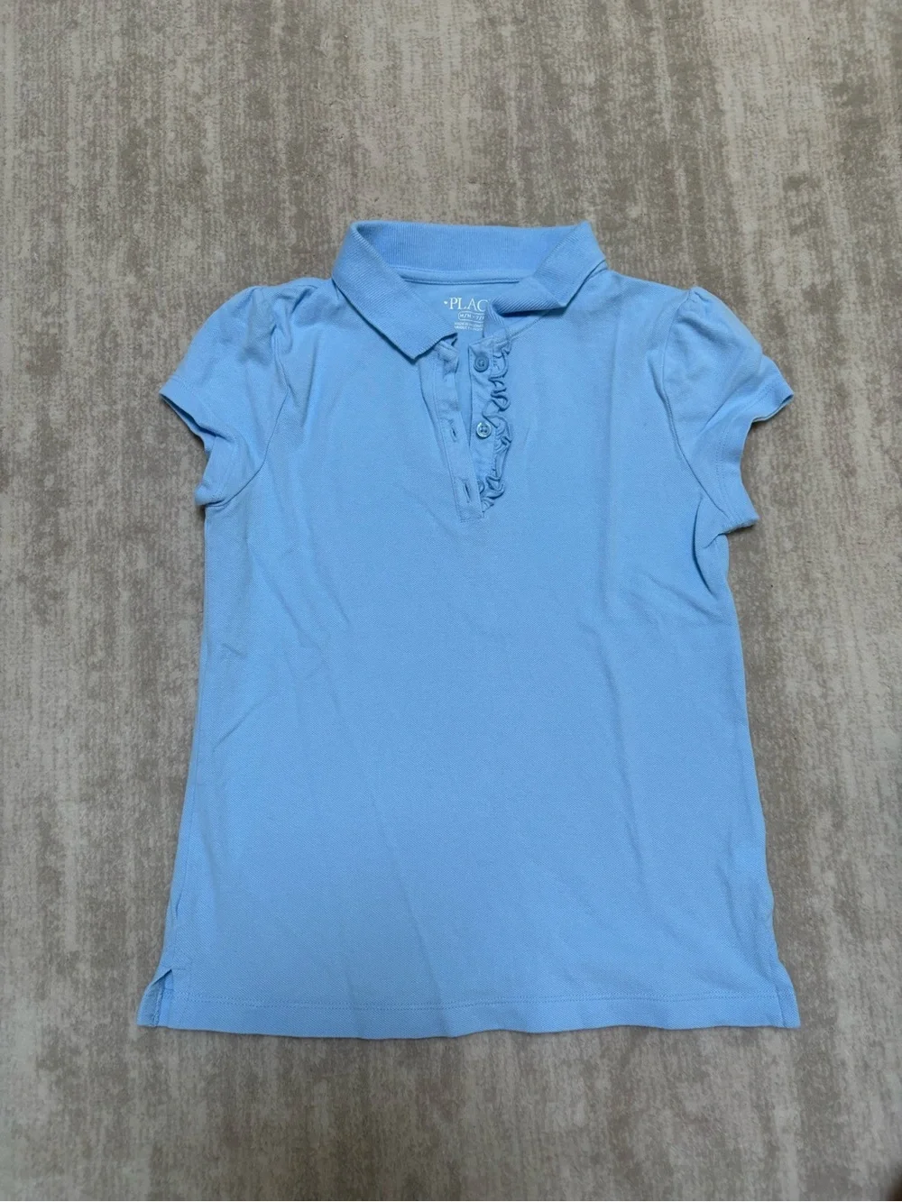The Children's Place Light Blue Polo shirt with ruffle trim. Size M (7-8)